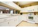 White kitchen features ample cabinetry and appliances at 11520 Shipwatch Dr # 1386, Largo, FL 33774