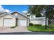 Two-car garage with additional storage space and landscaped yard at 11520 Shipwatch Dr # 1386, Largo, FL 33774