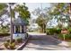 Gated entrance to the community with lush landscaping and palm trees at 11520 Shipwatch Dr # 1386, Largo, FL 33774