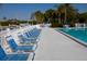 Community pool with lounge chairs for relaxing at 11520 Shipwatch Dr # 1386, Largo, FL 33774