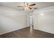 Bedroom with wood-look floors, ceiling fan and access to bathroom at 1600 67Th S Ave, St Petersburg, FL 33712