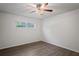 Spacious bedroom with wood-look flooring and ceiling fan at 1600 67Th S Ave, St Petersburg, FL 33712