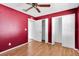 Bedroom with hardwood floors, ceiling fan and burgundy walls at 5204 New Brittany Ln, Zephyrhills, FL 33541