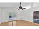 Bright living room with hardwood floors and sliding glass doors leading to a patio at 5204 New Brittany Ln, Zephyrhills, FL 33541