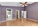 Primary bedroom with hardwood floors and access to bathroom and closet at 5204 New Brittany Ln, Zephyrhills, FL 33541