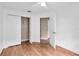 Well-lit bedroom featuring hardwood floors and a large closet at 5204 New Brittany Ln, Zephyrhills, FL 33541