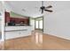 Living room, hardwood floors and kitchen access at 5204 New Brittany Ln, Zephyrhills, FL 33541