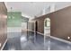 Open living room with dark hardwood floors and access to kitchen at 5204 New Brittany Ln, Zephyrhills, FL 33541