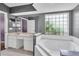 Primary bathroom with double vanity, large tub, and separate shower at 5204 New Brittany Ln, Zephyrhills, FL 33541