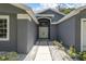 House entryway with double doors and stone walkway at 5204 New Brittany Ln, Zephyrhills, FL 33541