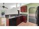 Kitchen with dark wood cabinets and a breakfast bar at 5204 New Brittany Ln, Zephyrhills, FL 33541