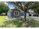 Gray house with white garage door and landscaping at 5204 New Brittany Ln, Zephyrhills, FL 33541
