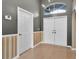 Bright entryway with tiled floor, double doors and a side door at 5204 New Brittany Ln, Zephyrhills, FL 33541