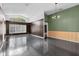 Large living room with dark hardwood floors, brown and green walls at 5204 New Brittany Ln, Zephyrhills, FL 33541