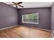 Bedroom with hardwood floors, window and purple walls at 5204 New Brittany Ln, Zephyrhills, FL 33541