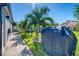 Private backyard with a covered grill and lush landscaping at 142 Beach Ave, Redington Shores, FL 33708