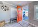 Open door revealing a glimpse of the home's interior and driveway at 142 Beach Ave, Redington Shores, FL 33708