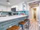 Kitchen with breakfast bar, white cabinets and stainless steel appliances at 142 Beach Ave, Redington Shores, FL 33708