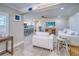 Living area with open concept to kitchen, coastal decor, and comfy seating at 142 Beach Ave, Redington Shores, FL 33708