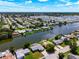 Aerial view showcasing a waterfront community with numerous homes and canals at 2248 Society Dr, Holiday, FL 34691