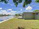 Landscaped backyard with canal view and patio at 2248 Society Dr, Holiday, FL 34691