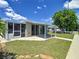 Backyard view of home with patio and canal access at 2248 Society Dr, Holiday, FL 34691