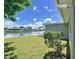 Side yard with canal view and lush landscaping at 2248 Society Dr, Holiday, FL 34691