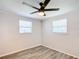Bedroom featuring grey vinyl flooring and a ceiling fan at 2248 Society Dr, Holiday, FL 34691