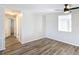 Bright bedroom with wood-look floors and access to hallway at 2248 Society Dr, Holiday, FL 34691
