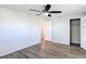 Bedroom with ceiling fan, grey vinyl flooring and white closet at 2248 Society Dr, Holiday, FL 34691