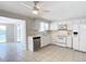Kitchen features white cabinets, stainless steel appliances, and tile floor at 2248 Society Dr, Holiday, FL 34691