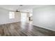Bright living room with grey vinyl flooring and ceiling fan at 2248 Society Dr, Holiday, FL 34691