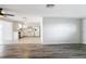 Open concept living room with kitchen view and grey vinyl flooring at 2248 Society Dr, Holiday, FL 34691