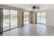 Bright living room with tile floors and sliding doors leading to a waterfront patio at 2248 Society Dr, Holiday, FL 34691