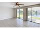 Living room with tile floors and sliding glass doors offering scenic water views at 2248 Society Dr, Holiday, FL 34691