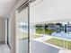 Waterfront patio accessible through sliding glass doors from the home's interior at 2248 Society Dr, Holiday, FL 34691