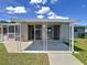 Covered patio with sliding glass doors and fenced yard at 2248 Society Dr, Holiday, FL 34691