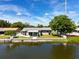 Waterfront home with patio, screened enclosure, and fenced backyard at 2248 Society Dr, Holiday, FL 34691