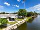 This waterfront property boasts a spacious backyard and patio at 2248 Society Dr, Holiday, FL 34691