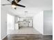 Open concept living room and kitchen with grey wood-look floors at 2248 Society Dr, Holiday, FL 34691
