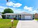 Exterior view of a single-story home with a two-car garage at 2248 Society Dr, Holiday, FL 34691