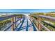 Wooden boardwalk leading to the beach over sand dunes at 142 Beach Ave, Redington Shores, FL 33708