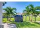 Landscaped backyard with grill and privacy fence at 142 Beach Ave, Redington Shores, FL 33708