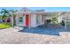 Front view of a charming bungalow with a covered carport at 142 Beach Ave, Redington Shores, FL 33708