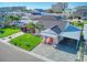 Aerial view of a charming house with a carport and well-maintained lawn at 142 Beach Ave, Redington Shores, FL 33708