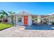 Brightly colored house exterior with a paved driveway at 142 Beach Ave, Redington Shores, FL 33708