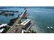 Aerial view of the building, featuring waterfront access, a pier, and bridge access to the island at 100 Bluff View Dr # 405C, Belleair Bluffs, FL 33770