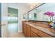 Bathroom with granite countertops, dual mirrors, and neutral tones, providing a clean and modern aesthetic at 100 Bluff View Dr # 405C, Belleair Bluffs, FL 33770