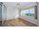 Bright bedroom with large windows, tile floors, and natural light at 100 Bluff View Dr # 405C, Belleair Bluffs, FL 33770
