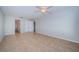 Spacious bedroom with neutral walls and tiled flooring, featuring a ceiling fan and large closet at 100 Bluff View Dr # 405C, Belleair Bluffs, FL 33770